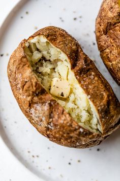 an open baked potato sitting on top of a white plate