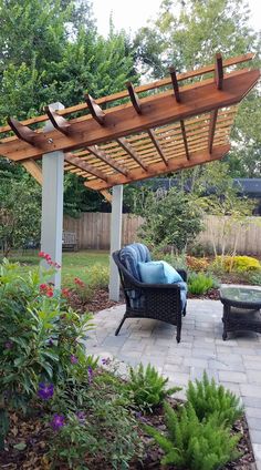 an outdoor patio with chairs and a pergolan