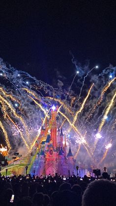 fireworks are lit up in the sky above a castle