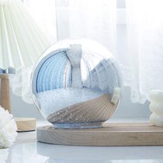 a glass ball sitting on top of a wooden stand