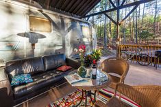 a living area with couches, chairs and an airstream