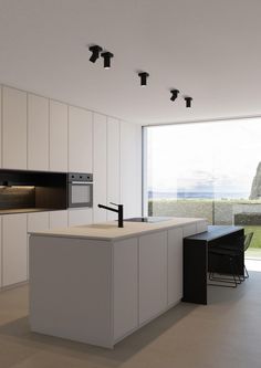 a modern kitchen with an island counter and oven