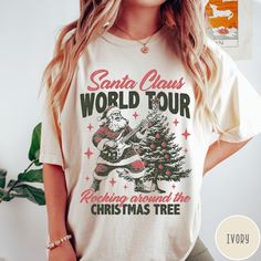 Santa Claus World Tour Comfort Colors® T-Shirt, Retro Christmas Shirt, Vintage Christmas Shirt, Rocking Around Tshirt, Trendy Holiday Tee 🧵 HOW TO ORDER   - Pick your size and color from the drop down menus  - Review the sizing and color options in the listing photos  - Add the item to your cart and complete the checkout process  - We'll start working on your order right away! 🧵SIZING  - Please review the listing photos to see the size charts  - These photos will also show you how to order a regular/relaxed fit or an oversized fit 🧵PRODUCT DETAILS  - Comfort Colors 1717 garment-dyed t-shirt - made 100% with ring-spun cotton. The soft-washed, garment-dyed fabric brings extra coziness to your wardrobe while the relaxed fit makes it an excellent daily choice. The double-needle stitching th Christmas Tshirts Designs, Vintage Christmas Shirt, Retro Christmas Shirt, Streetwear Tshirt, Christmas Tees, Retro Christmas, Size Charts, Holiday Fashion, Christmas Shirt