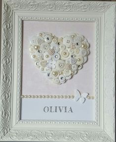 a white frame with buttons in the shape of a heart and name written on it