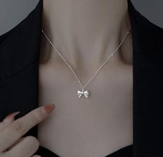 Add a touch of sophistication and charm to any outfit with this stunning Silver Bow Pendant Necklace. Crafted with meticulous attention to detail, this necklace features a delicate bow pendant that exudes timeless elegance. Features: - Material: High-quality sterling silver - Design: Intricately designed bow pendant for a classic and feminine look - Chain Length: Adjustable chain for a perfect fit, ranging from 16 to 18 inches - Clasp: Secure lobster clasp for easy wear and removal Highlights: - Versatile Style: Perfect for everyday wear or special occasions - Elegant Finish: Polished silver finish that shines beautifully - Gift-Ready: Ideal gift for birthdays, anniversaries, or any special occasion Care Instructions: - Store in a cool, dry place when not in use - Avoid contact with water Formal Butterfly Knot Necklace, Sterling Silver Bow Jewelry For Anniversary, Formal Sterling Silver Ribbon Jewelry, Formal Sterling Silver Jewelry With Ribbon, Elegant Bow Necklace For Anniversary, Silver Bow Jewelry As A Gift, Classic Silver Jewelry With Bow, Classic Silver Jewelry With Bow Detail, Silver Bow Jewelry For Gift