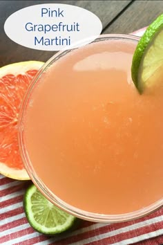 a pink grapefruit martini garnished with lime