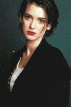 a woman in a black jacket and white shirt