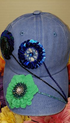 a blue hat with flowers and beads on it