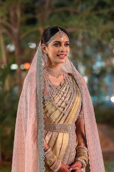 a woman in a bridal gown with jewelry on her head and veil over her face