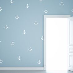 an open door in front of a wall with white anchors on it