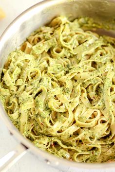 creamy pesto pasta in a pan with text overlay