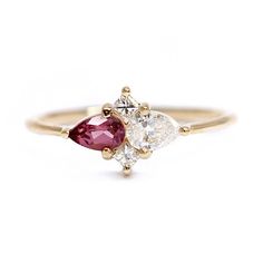 a three stone ring with two pear shaped diamonds