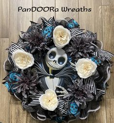 a wreath with flowers and a skeleton on it that says, pandora wreaths