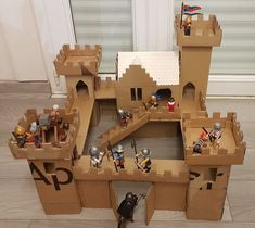 a cardboard castle made to look like it has knights inside