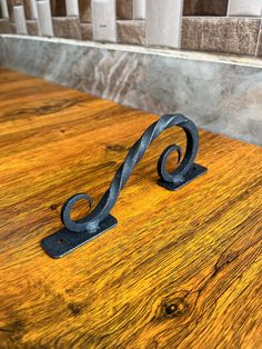 a wooden table with a metal handle on it