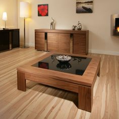 a modern living room with wood floors and an open fire place in the center table