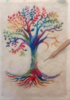 a tree with colorful leaves and branches painted on it, next to a paintbrush