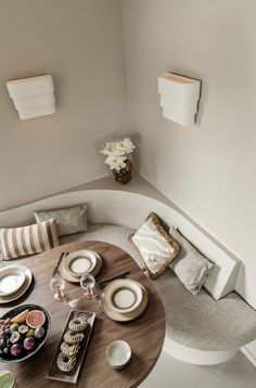 an overhead view of a table with plates and food on it in the corner of a room