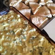 a casserole dish with tortilla chips on the side