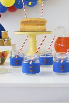 there is a cake on the table with blue and red striped straws in front of it