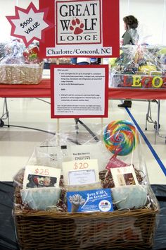 a table with baskets and signs on it for people to buy items at the great wolf lodge