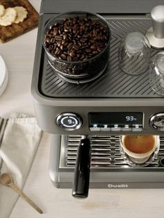 an espresso machine filled with coffee on top of a counter