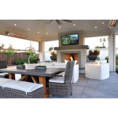 an outdoor living area with furniture and a fireplace