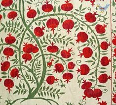 an intricately designed wall hanging with red flowers and green leaves on it's sides