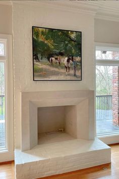 an empty room with a painting on the wall and two horses standing in the background