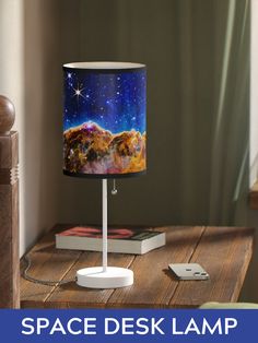 the space desk lamp is on top of a wooden table