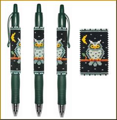 three pens with designs on them and one has an owl in the middle, while the other two are green