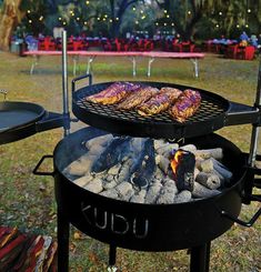 the grill is full of meat and vegetables