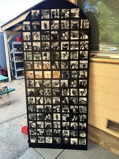 a black and white photo is on display in front of a building with many pictures