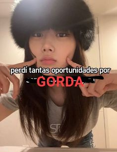 a woman wearing a black hat with the words gorda written on it