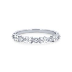 a white gold wedding band with five diamonds on the top and bottom, set in 18k