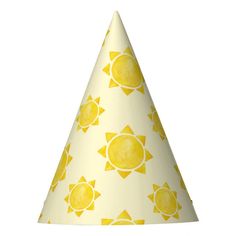 a yellow and white party hat with sun designs