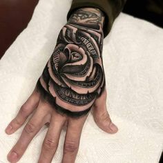 a man's hand with a tattoo on it