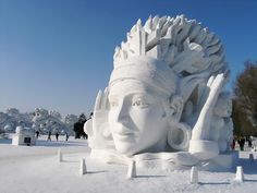 a large white sculpture sitting in the middle of a snow covered field