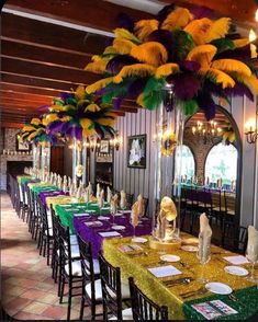 the tables are decorated with colorful feathers and place settings