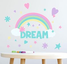 a child's room with a rainbow and stars wall decal