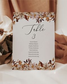 a table number card with flowers on it