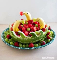 a bowl filled with fruits and vegetables on top of a table