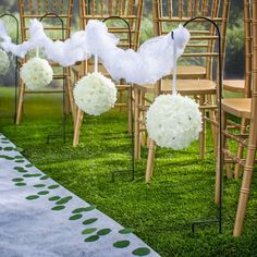 the chairs are decorated with white flowers and tulle for an elegant touch to the ceremony