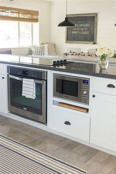 a kitchen with an oven, stove and sink in it's center island area