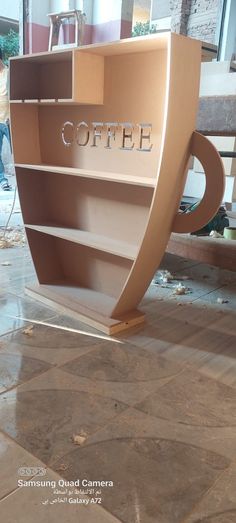 a coffee shop sign sitting on top of a tiled floor