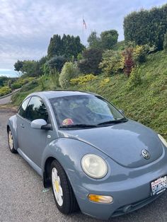 a blue car parked on the side of a road