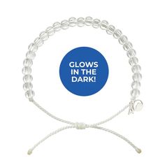 glows in the dark bracelet with white cord and blue circle on it's side