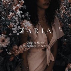 a woman standing in front of flowers with the words zaria