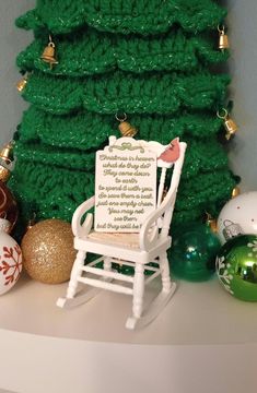 a white rocking chair sitting in front of a christmas tree with a poem written on it