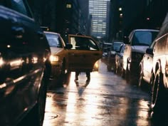 a man is walking down the street in the rain